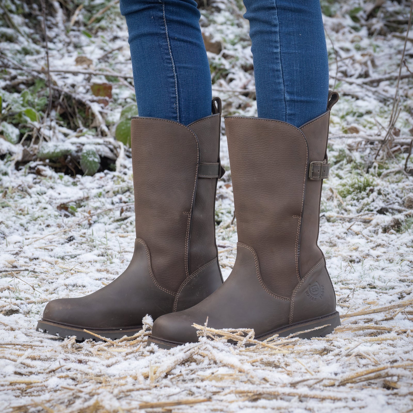 Brown Quebec waterproof mid-calf boots worn in snowy countryside
