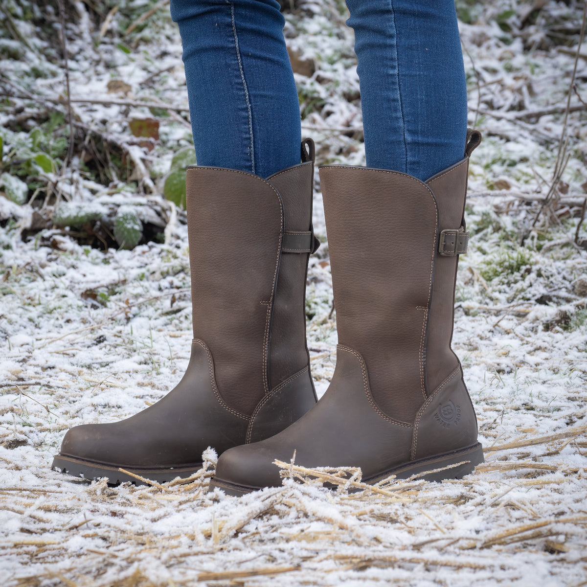 Brown Quebec waterproof mid-calf boots worn in snowy countryside