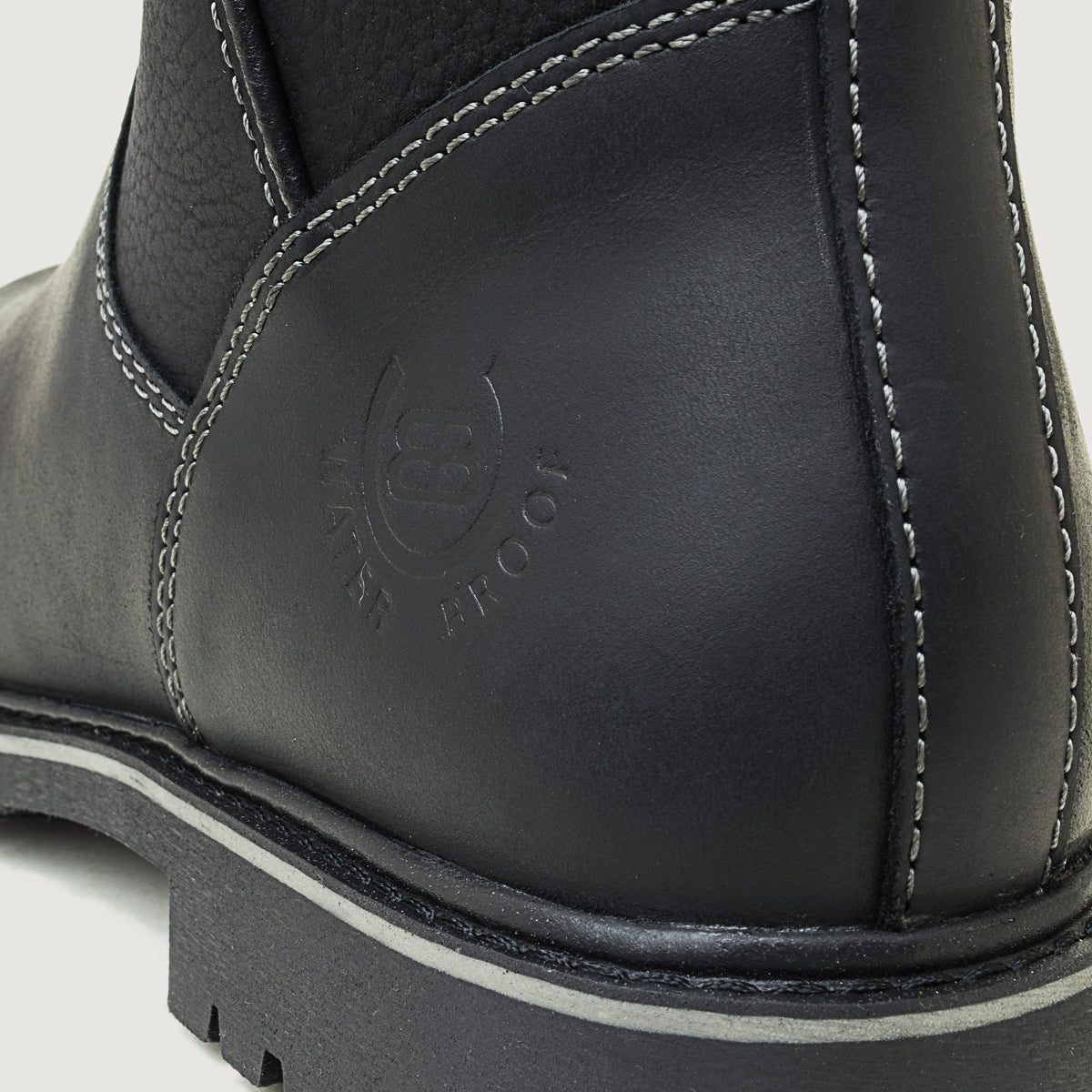 Bareback Quebec waterproof ankle boots in black leather, close-up of the embossed waterproof logo on the heel