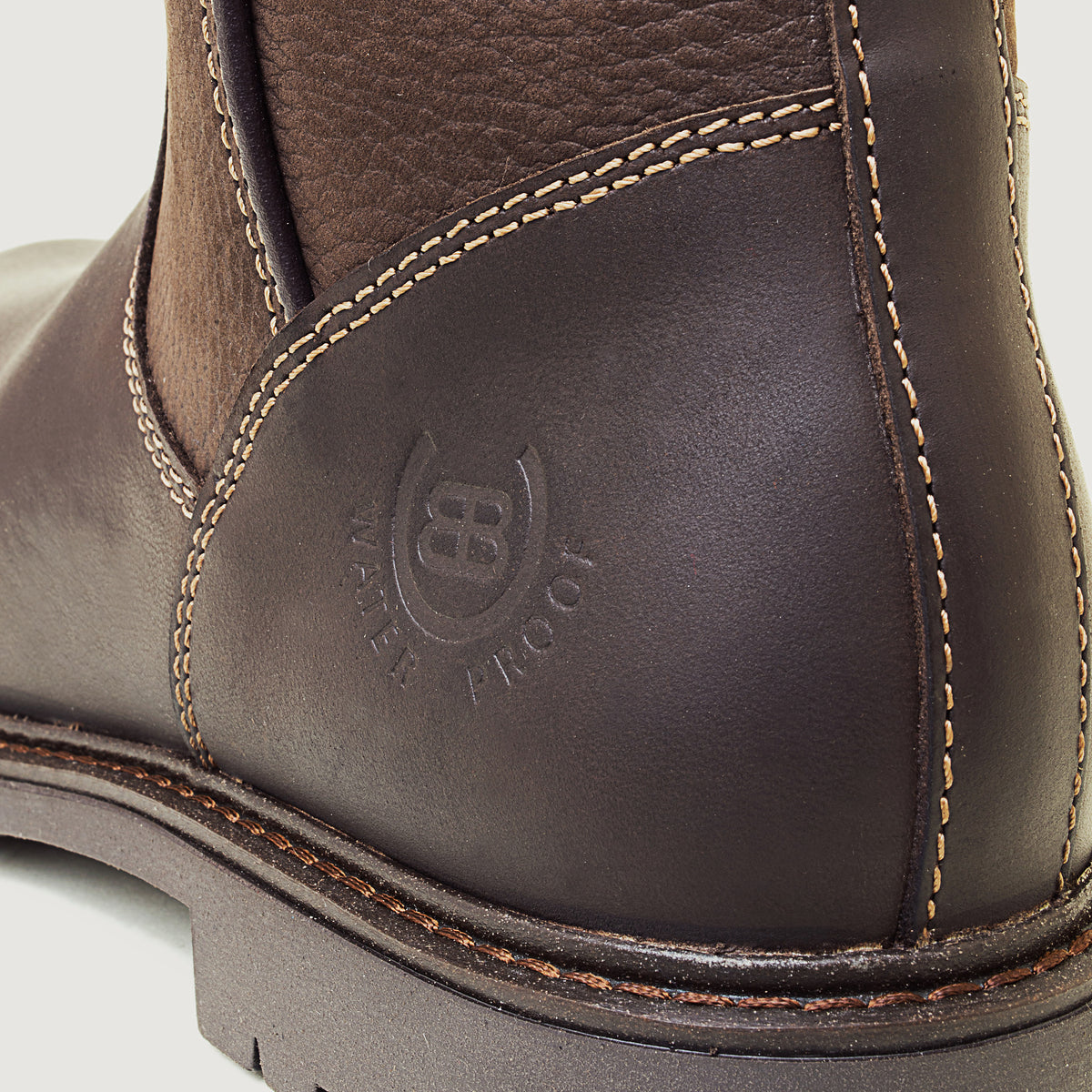 Bareback Quebec waterproof ankle boots in brown leather, close-up of the embossed waterproof logo on the heel