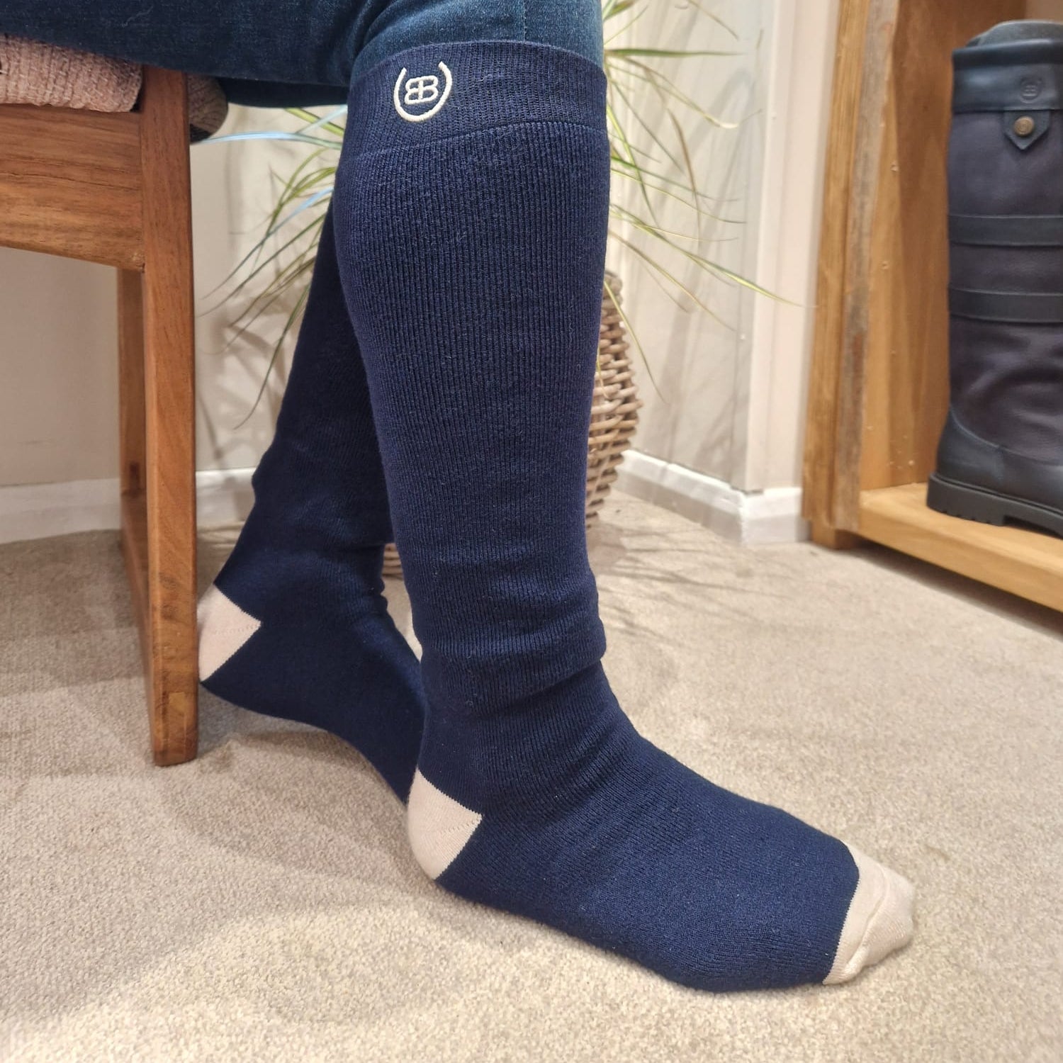 Person wearing navy knee-high socks with Bareback Logo