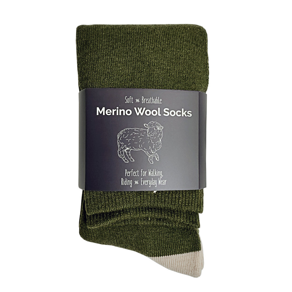 Green merino wool socks with a label on a white background