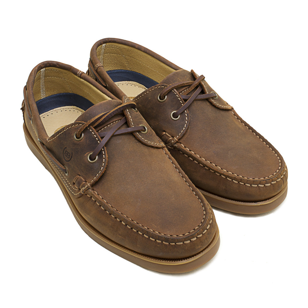 Pair of brown leather boat shoes on a white background