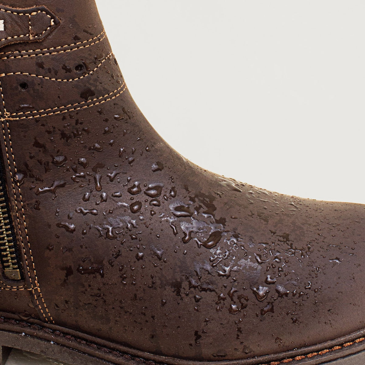 Bareback Hudson Ankle waterproof boots in chocolate leather, close-up showing water beading on the leather