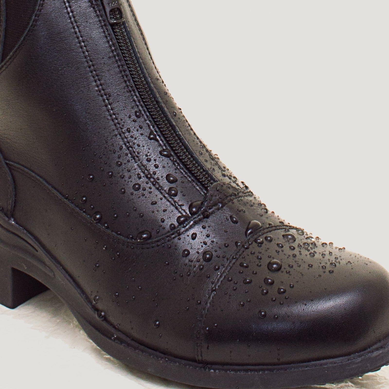 Bareback Idaho Storm waterproof jodhpur riding boots in black leather, close-up showing water beading on the leather