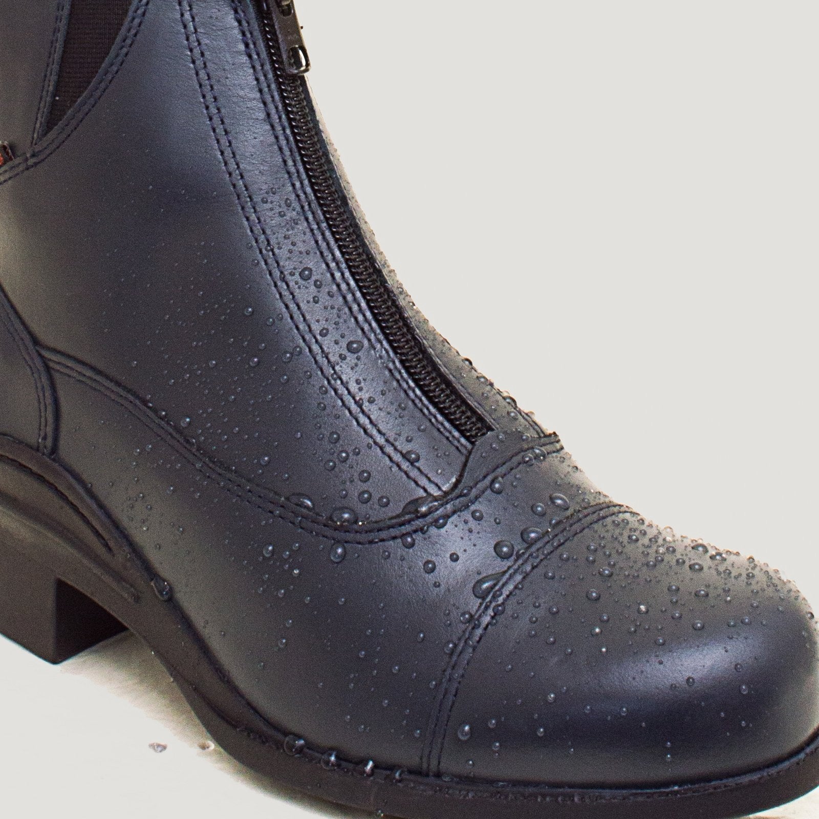 Bareback Idaho Storm waterproof jodhpur riding boots in navy leather, close-up showing water beading on the leather