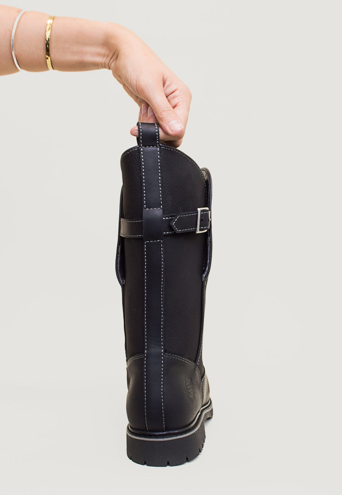 Bareback Quebec waterproof mid calf boots in black, close-up of a hand pulling the rear pull tab