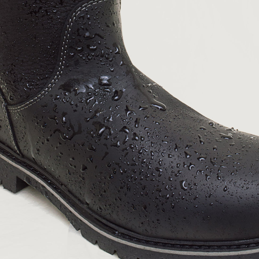 Bareback Quebec waterproof mid calf boots in black, close-up of water droplets beading on the waterproof leather