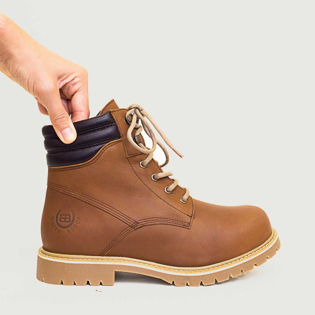 Bareback Rocky waterproof boots in copper, close-up of a hand pressing the padded ankle collar