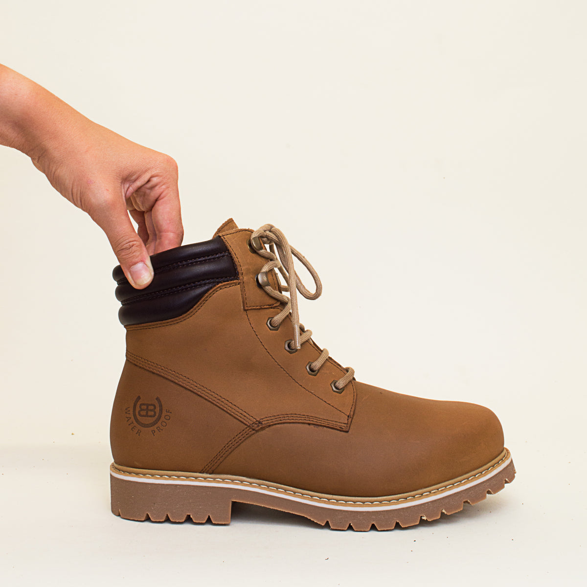 Bareback Rocky Winter waterproof boots in mocha, close-up of a hand pressing the padded ankle collar