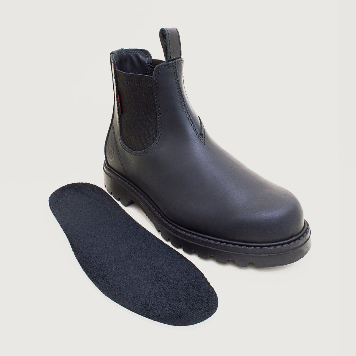 Bareback Vancouver Storm waterproof boots in black, standing beside the removable suede-topped insole
