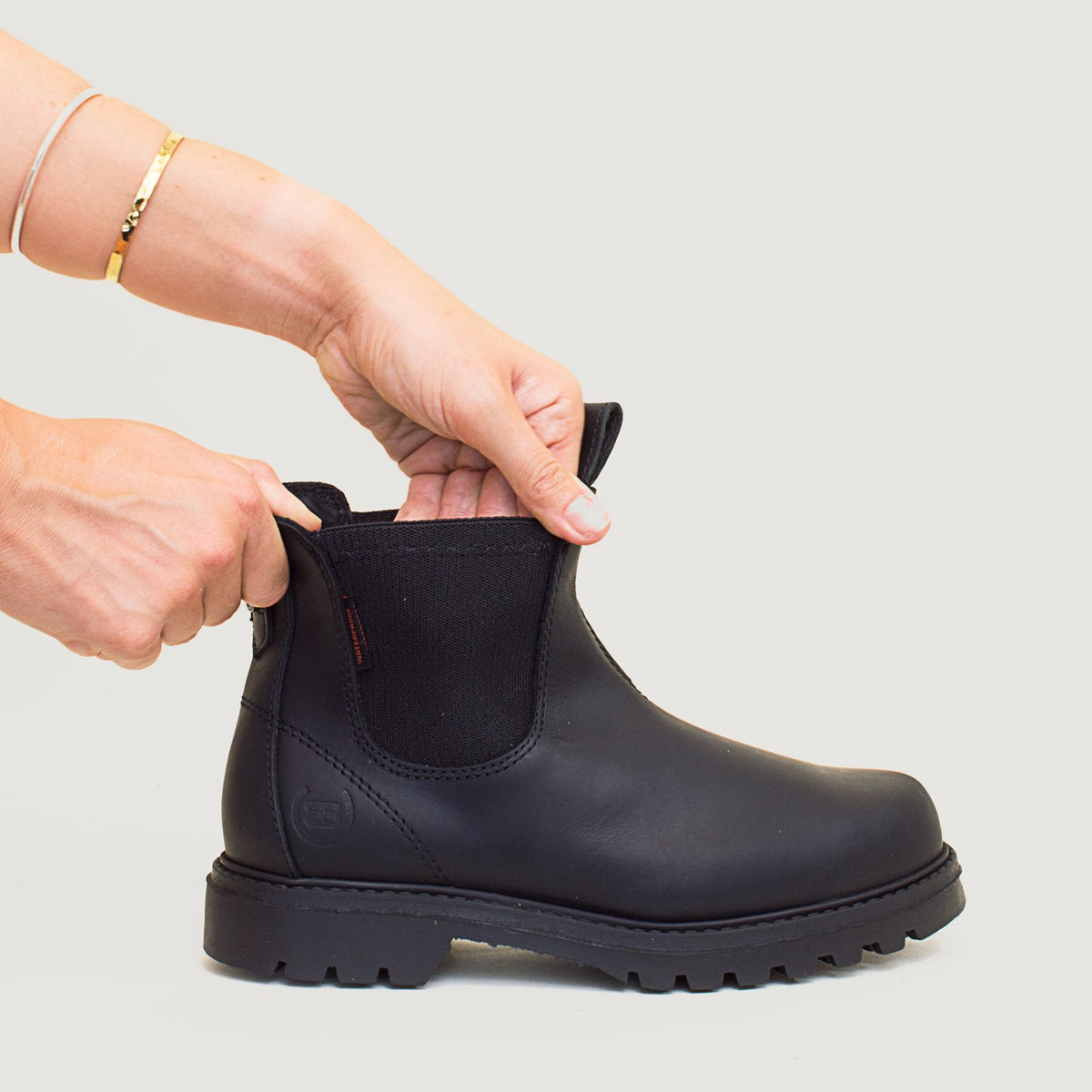 Bareback Vancouver Storm waterproof boots in black, close-up of hands stretching the elastic side panel