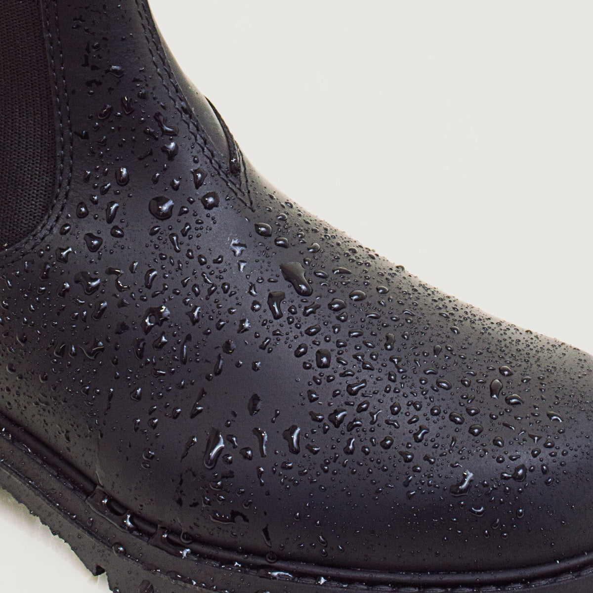Bareback Vancouver Storm waterproof boots in black, close-up of water droplets beading on the waterproof leather